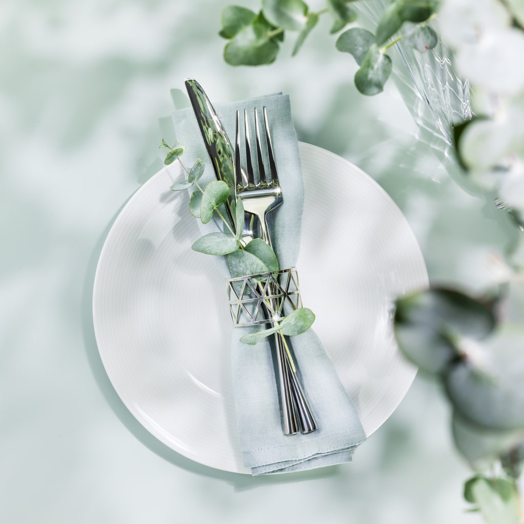 Springtime luncheon table setting with greenery